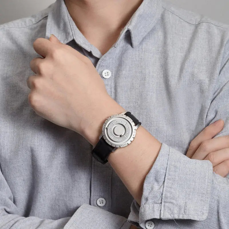 Men's watch with a magnetic pointer in the form of an iron ball